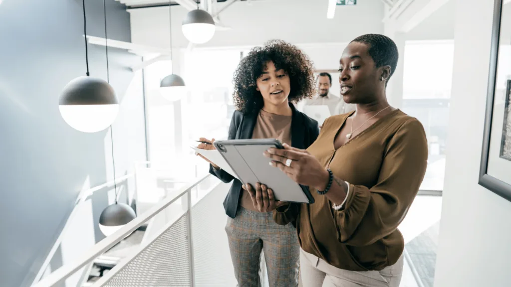 Management team looking at a checklist on how to outsource customer service