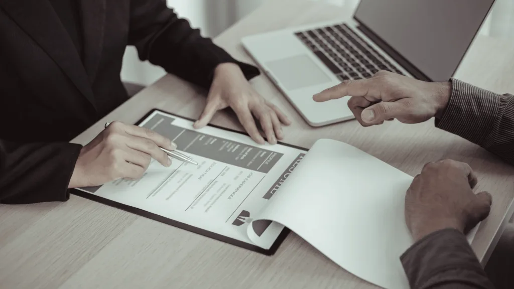 Hiring manager sifting through resumes to find the right customer service representative