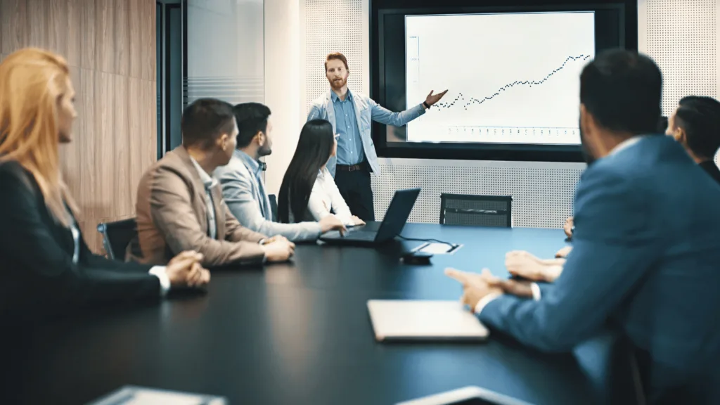 Customer service team discussing a graph that looks like the data on live chat metrics is increasing