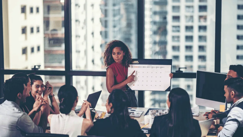 Team leader discussing how to handle customer interactions effectively and efficiently to a group of support agents.