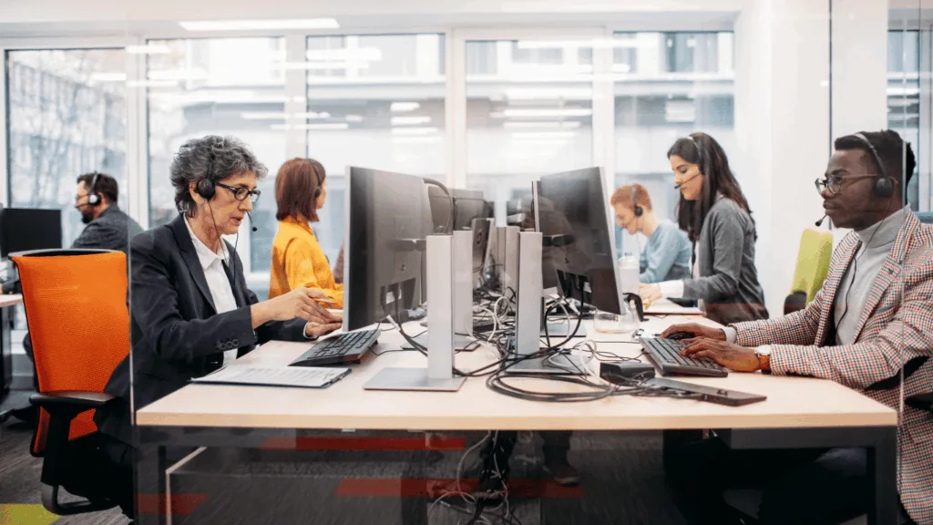 Busy customer support agents dealing with customer queries