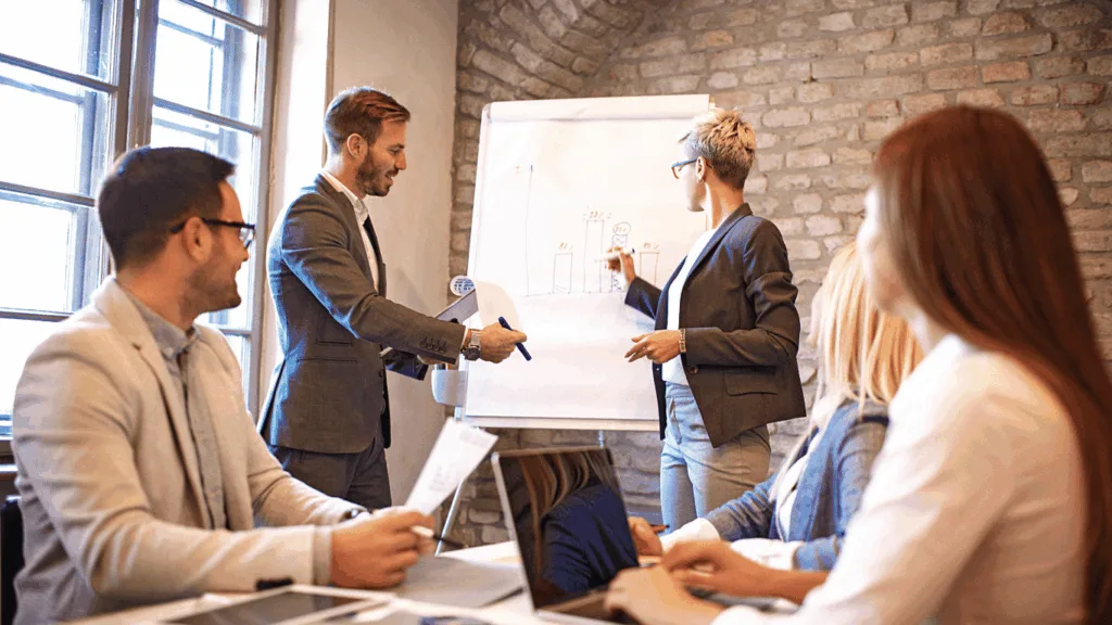 Business management team reviewing changes in metrics since outsourcing customer support to a third party service provider